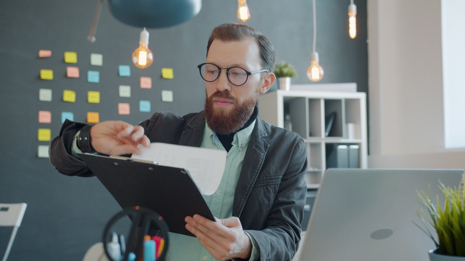 Professional reviewing documents to audit citations before submitting a graduate paper