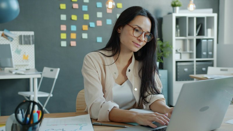 Professional learning how to manage graduate school while starting a new job at an office desk