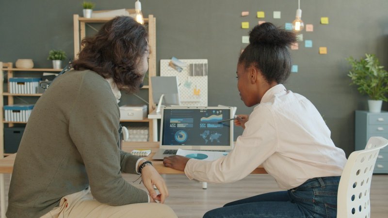 Two researchers discussing how to use member checking in qualitative research