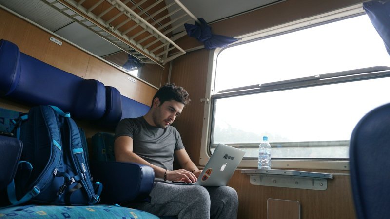 Professional on a train learning how to manage graduate school with a long commute